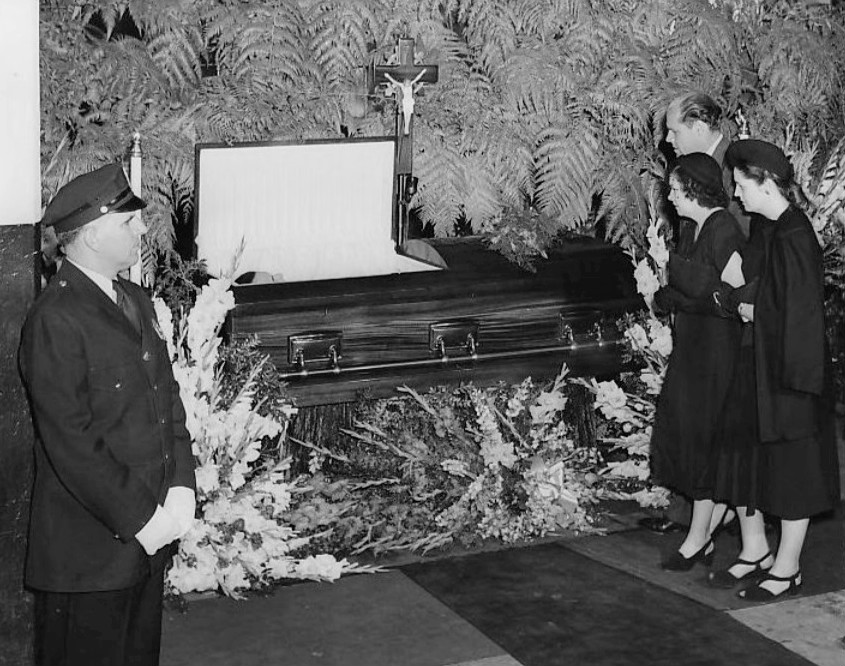 A Mother and son looking into Babe Ruth's open casket at Yankee